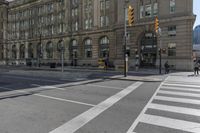 a crosswalk on the road near some building's windows and one with traffic lights