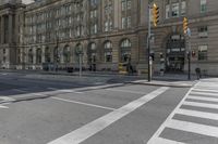 a crosswalk on the road near some building's windows and one with traffic lights