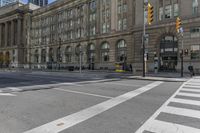 a crosswalk on the road near some building's windows and one with traffic lights