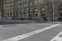 a crosswalk on the road near some building's windows and one with traffic lights