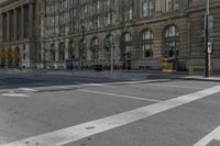 a crosswalk on the road near some building's windows and one with traffic lights