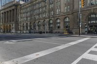 a crosswalk on the road near some building's windows and one with traffic lights