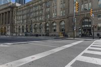 a crosswalk on the road near some building's windows and one with traffic lights