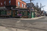 a empty city street with a small restaurant in the background on the corner of the intersection