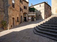 a view of a narrow courtyard with some stairs and steps up to it as well