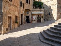 a view of a narrow courtyard with some stairs and steps up to it as well