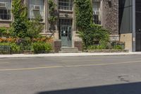 an old building with ivy on the side and benches sitting in front of it and in front of plants and buildings