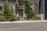 an old building with ivy on the side and benches sitting in front of it and in front of plants and buildings