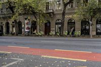 a bicycle sitting next to a street with people eating out of tables on it and parked in front