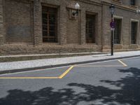 the side walk and walkway of a building is marked with markings for parking spaces below