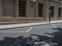 the side walk and walkway of a building is marked with markings for parking spaces below