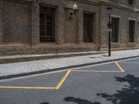 the side walk and walkway of a building is marked with markings for parking spaces below