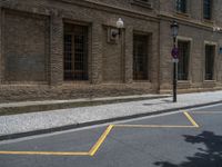 the side walk and walkway of a building is marked with markings for parking spaces below