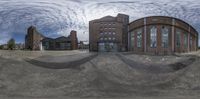 a very wide shot of a large building in the center of a street with an interesting look to it