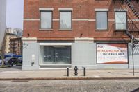 a store in the middle of a city with a red and orange banner on it