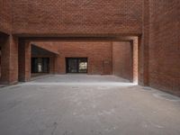 a large brick building that has a few windows and windows on it's front