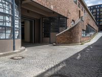 a very long brick building with lots of windows and stairs leading up to it's outside