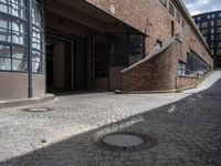 a very long brick building with lots of windows and stairs leading up to it's outside