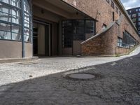 a very long brick building with lots of windows and stairs leading up to it's outside