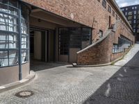 a very long brick building with lots of windows and stairs leading up to it's outside