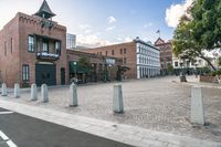 the town hall sits empty and on its side on a street corner surrounded by brick buildings