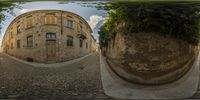 the reflection of a building is shown from below the picture with the circular mirror of the street