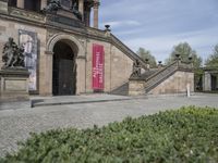 Berlin City Architecture: Classic Mansion on Cobblestone Road with Green Grass and Trees