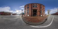 a circular photo of a building and intersection taken from outside with a fisheye lens