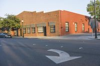 the intersection of a street with the building in the background with one arrow pointing upwards