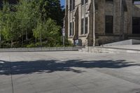 a person on a skate board doing a trick on concrete slabs in front of an old building