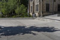 a person on a skate board doing a trick on concrete slabs in front of an old building