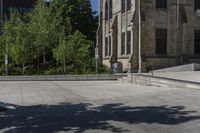 a person on a skate board doing a trick on concrete slabs in front of an old building