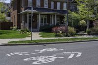 a house with a bike lane sign on a sidewalk in front of it at a residential neighborhood