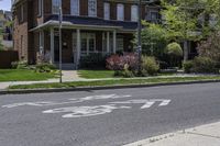 a house with a bike lane sign on a sidewalk in front of it at a residential neighborhood