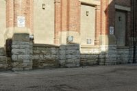 a building with brick walls has no cars parked by it in front of it and no one is visible