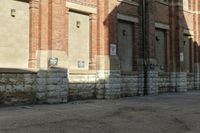 a building with brick walls has no cars parked by it in front of it and no one is visible