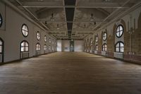 an empty hall with lots of windows and a large mirror above the space to look into the sky