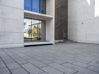 the empty courtyard is very clean and empty of people walking outside of the building,