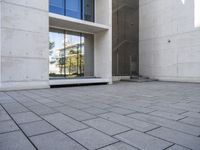 the empty courtyard is very clean and empty of people walking outside of the building,