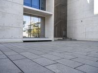 the empty courtyard is very clean and empty of people walking outside of the building,