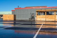 the parking lot at a small restaurant has been cleaned to clear out from the rain