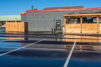 the parking lot at a small restaurant has been cleaned to clear out from the rain