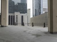 an empty concrete floor in front of skyscrapers and buildings that is being cleaned with white foam