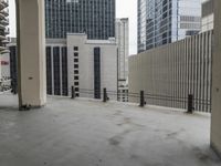 an empty concrete floor in front of skyscrapers and buildings that is being cleaned with white foam