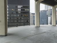 an empty concrete floor in front of skyscrapers and buildings that is being cleaned with white foam