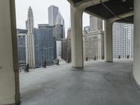 an empty concrete floor in front of skyscrapers and buildings that is being cleaned with white foam