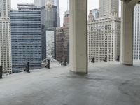 an empty concrete floor in front of skyscrapers and buildings that is being cleaned with white foam