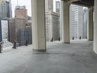 an empty concrete floor in front of skyscrapers and buildings that is being cleaned with white foam