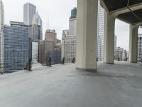 an empty concrete floor in front of skyscrapers and buildings that is being cleaned with white foam