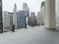 an empty concrete floor in front of skyscrapers and buildings that is being cleaned with white foam